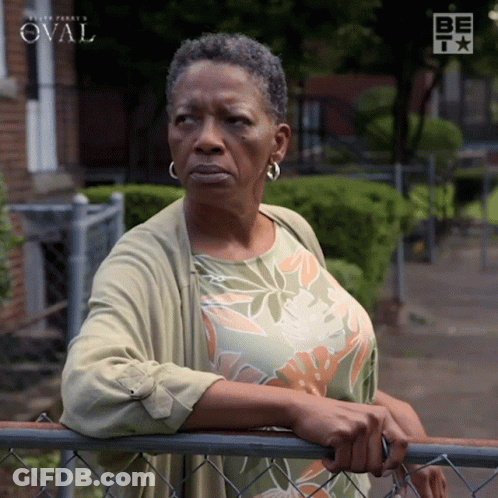Woman Leaning On Chain Link Fence With Oval GIF