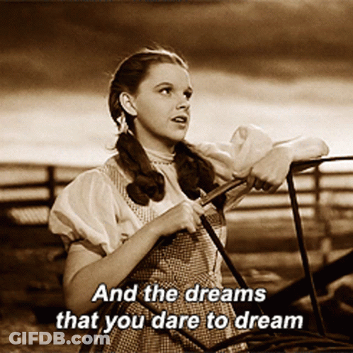 Woman Leaning On Railing With Dream Words GIF