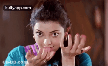 Woman Licking Lips In Blue Shirt GIF