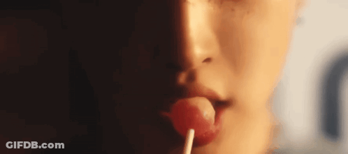 Woman Licking Lollipop Close-Up GIF