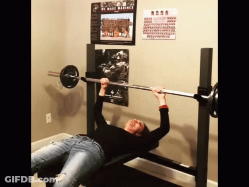 Woman Lifting Barbell In Front Of We Make Marines Poster GIF