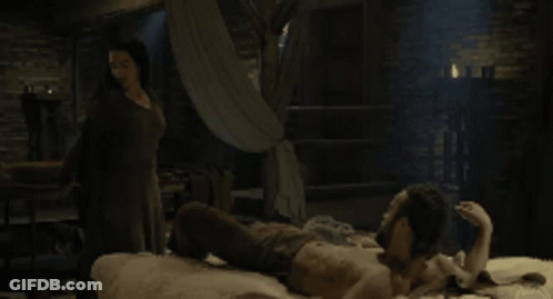 Woman Looking At Another Woman In Dark Room GIF