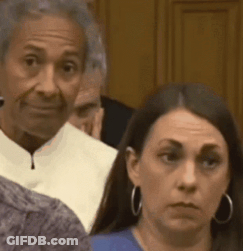 Woman Looking At Camera In Room GIF