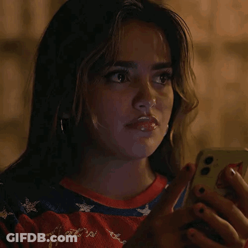 Woman Looking At Cell Phone In Dark GIF