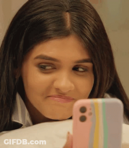 Woman Looking At Cell Phone Making Face GIF