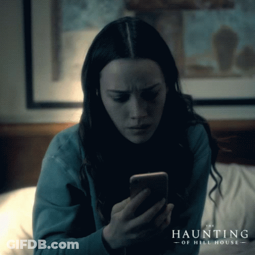 Woman Looking At Cell Phone With The Haunting Of Hill House GIF