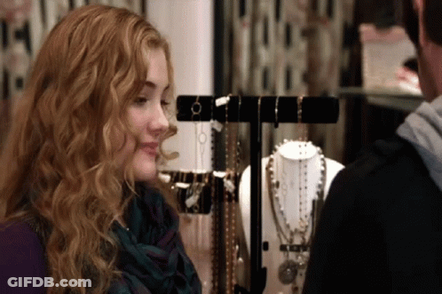 Woman Looking At Display Of Necklaces And Bracelets GIF