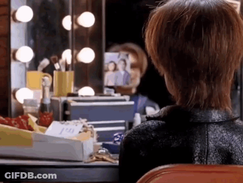 Woman Looking At Herself In Dressing Room Mirror GIF