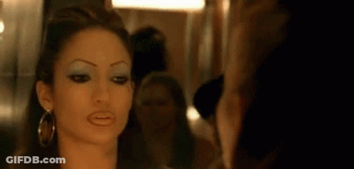 Woman Looking At Herself In Mirror GIF