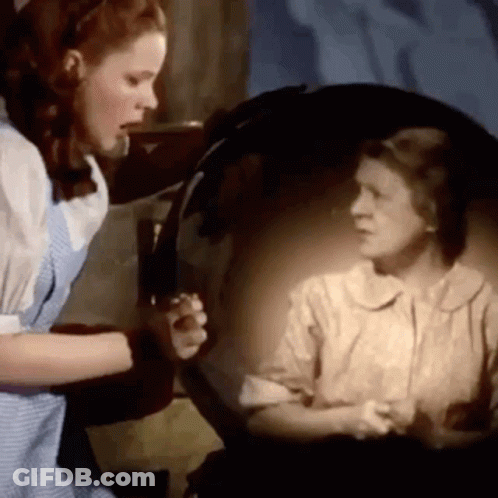 Woman Looking At Herself In Mirror GIF