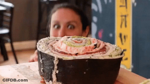 Woman Looking At Large Sushi Roll GIF