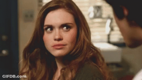 Woman Looking At Man In Room GIF
