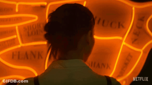 Woman Looking At Netflix Neon Sign GIF