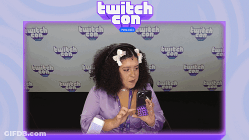 Woman Looking At Phone At Twitch Con GIF