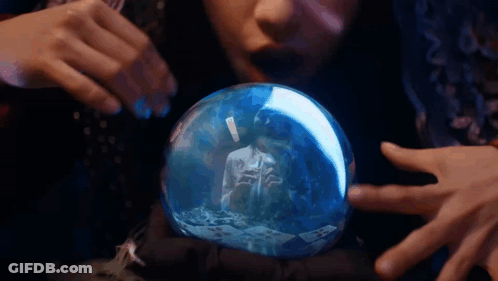 Woman Looking At Snow Globe With Man Reflection GIF