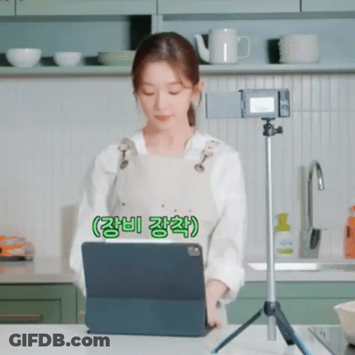 Woman Looking At Tablet On Tripod In Kitchen GIF