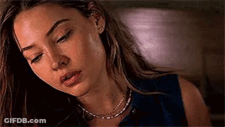 Woman Looking Down With Necklace And Earrings GIF