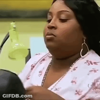 Woman Looking In Mirror Wearing Earrings GIF