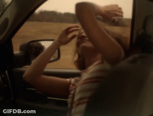 Woman Looking Out Car Window Holding Head GIF
