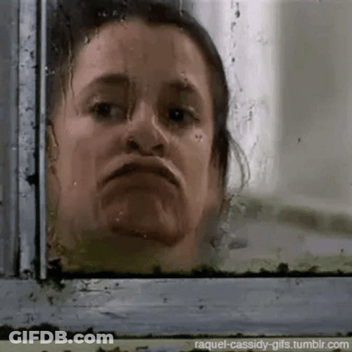 Woman Looking Out The Window GIF