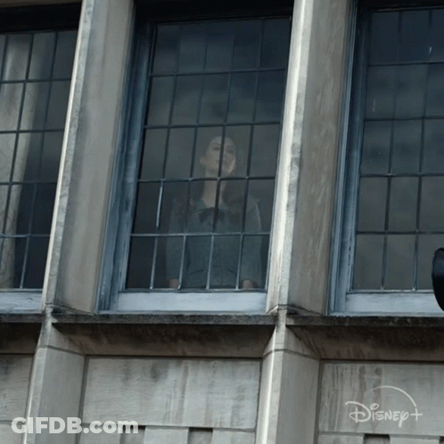 Woman Looking Out Window With Disney Logo GIF