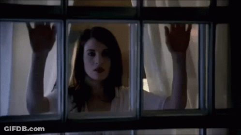 Woman Looking Out Window With Hands On Glass GIF