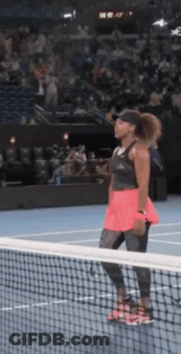 Woman Looking Over Net On Tennis Court GIF