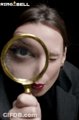 Woman Looking Through Magnifying Glass GIF