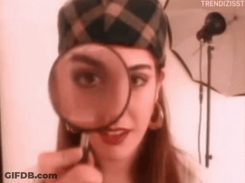 Woman Looking Through Magnifying Glass GIF