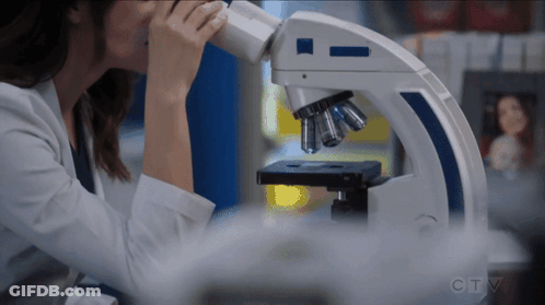 Woman Looking Through Microscope With CTV GIF