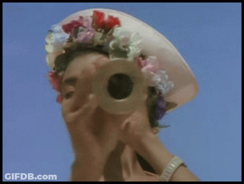 Woman Looking Through Telescope With Flower Hat GIF