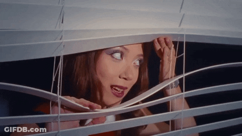 Woman Looking Through Window Blind Mouth Open GIF
