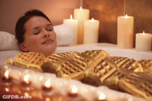 Woman Lying In Bathtub Surrounded By Candles GIF