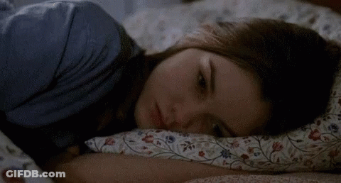 Woman Lying In Bed Looking At Camera GIF