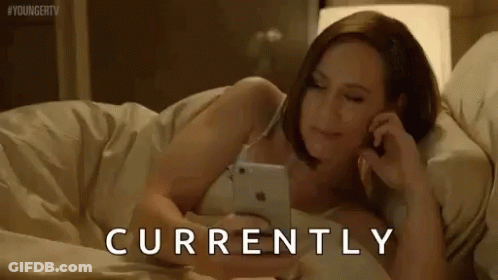 Woman Lying In Bed Talking On Phone GIF