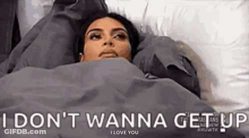 Woman Lying In Bed Under Blanket I Don't Wanna Get Up GIF