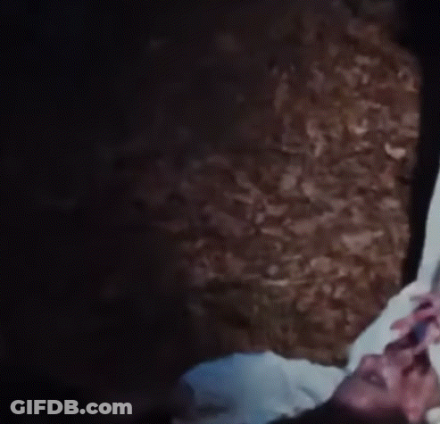 Woman Lying In Dark Room Reaching Out GIF