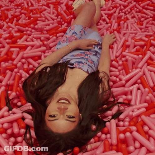 Woman Lying In Pink Sprinkles GIF