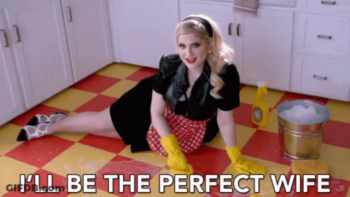 Woman Lying On Kitchen Floor In Yellow Gloves GIF
