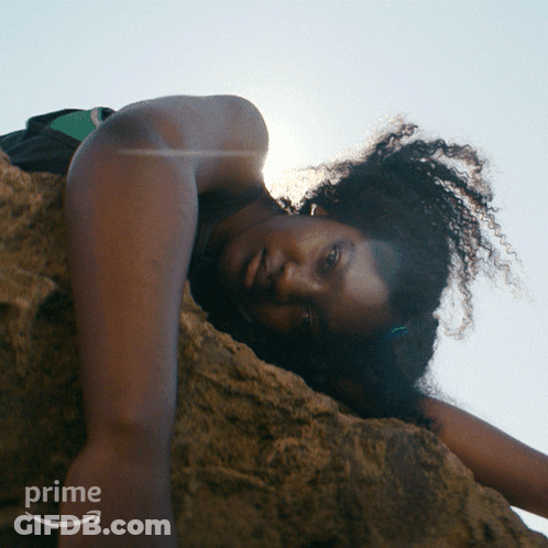 Woman Lying On Rock With Prime Logo GIF