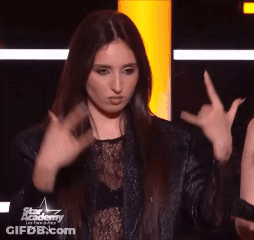 Woman Making Devil Horns Sign With Fingers GIF