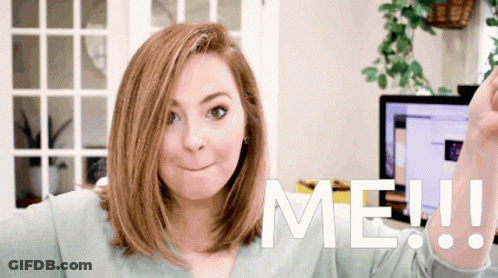 Woman Making Face In Front Of Sign Saying Me GIF