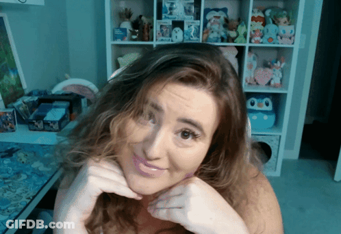 Woman Making Face In Front Of Toy Shelf GIF