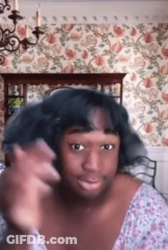 Woman Making Funny Face At Floral Wall GIF