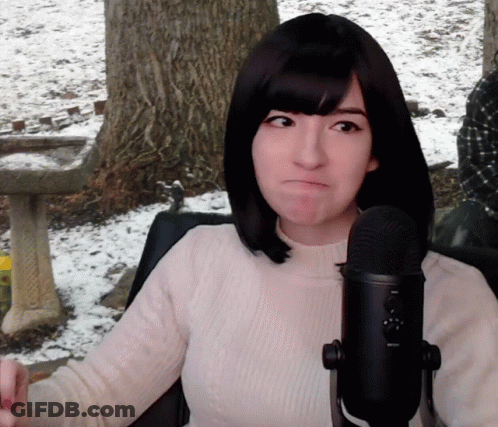 Woman Making Funny Face At Microphone GIF