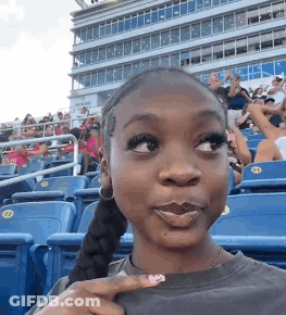 Woman Making Funny Face At Stadium GIF
