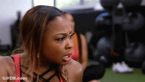 Woman Making Funny Face Holding Dumbbell GIF