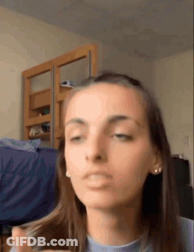 Woman Making Funny Face Holding Hair GIF