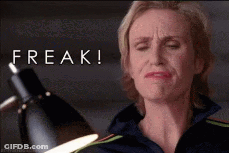Woman Making Funny Face Holding Lamp With Freak Above GIF