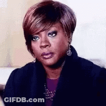 Woman Making Funny Face In Black Jacket And Earrings GIF